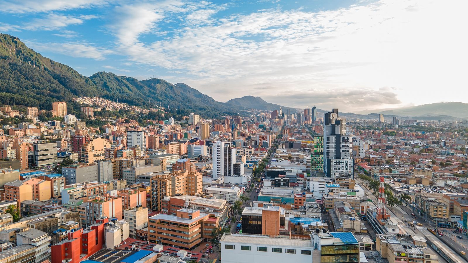 Widok z lotu ptaka na Bogotę w Kolumbii, ukazujący nowoczesną architekturę na tle malowniczego krajobrazu górskiego