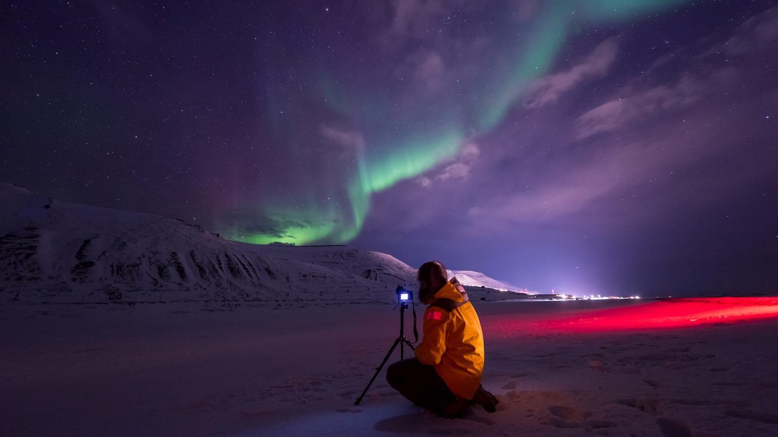 Mężczyzna fotografujący zorzę polarną