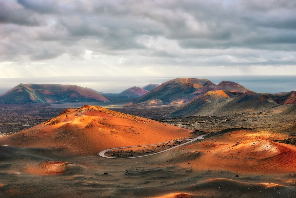 The road leading between the mountains and volcanoes of Lanzarote