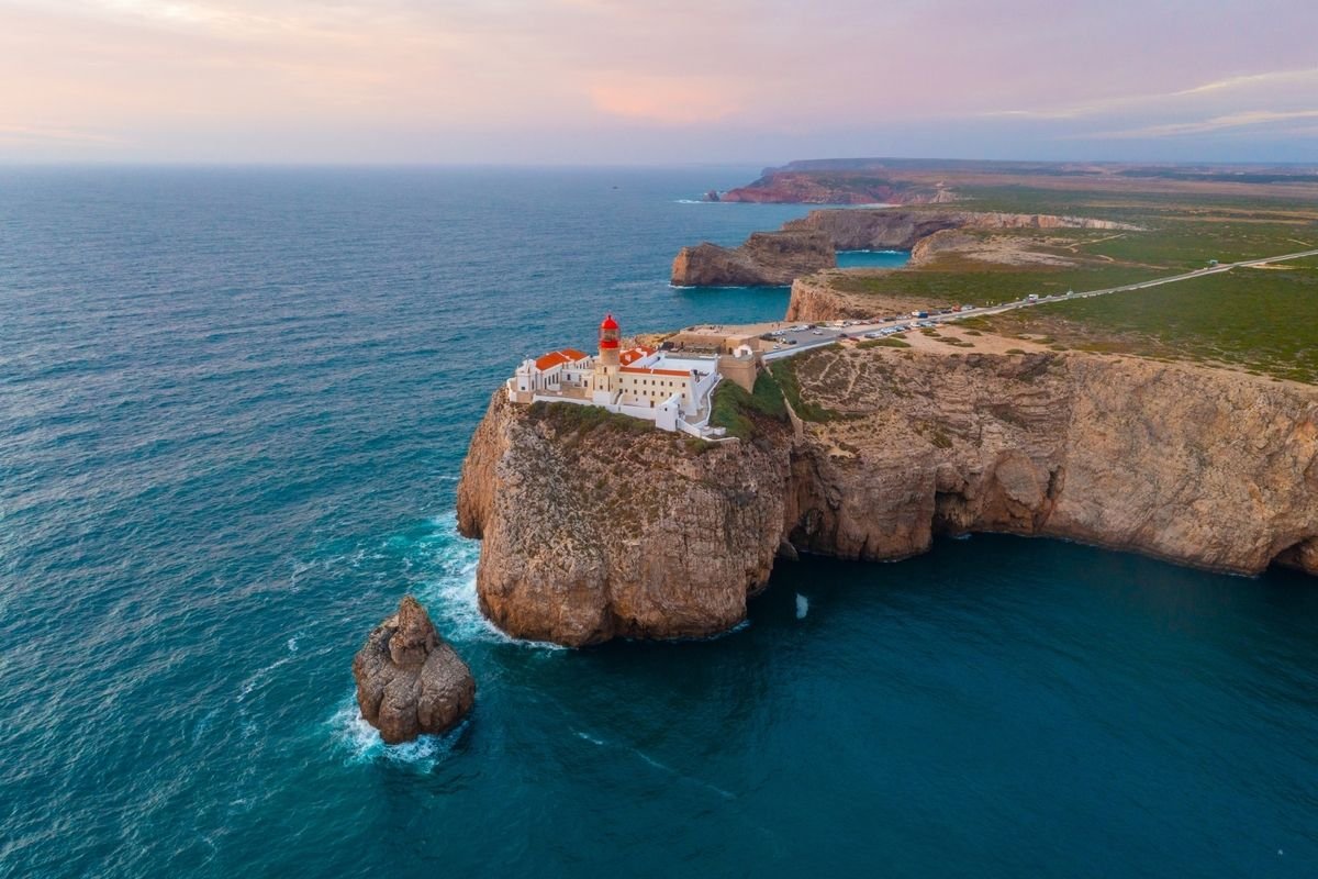 A lighthouse at the end of a promontory in the Algarve