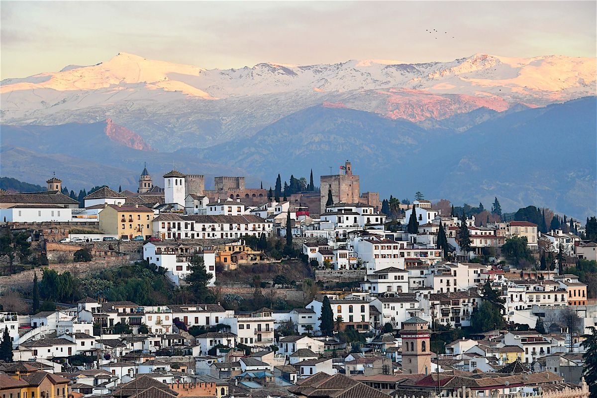The peaks of the Sierra Nevada Mountains are visible in Malaga, Spain